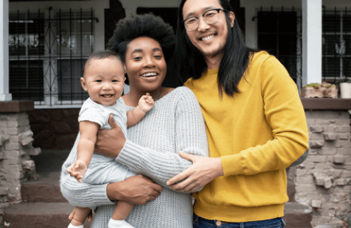 Family standing outside of home